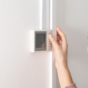 Homeowner checking thermostat